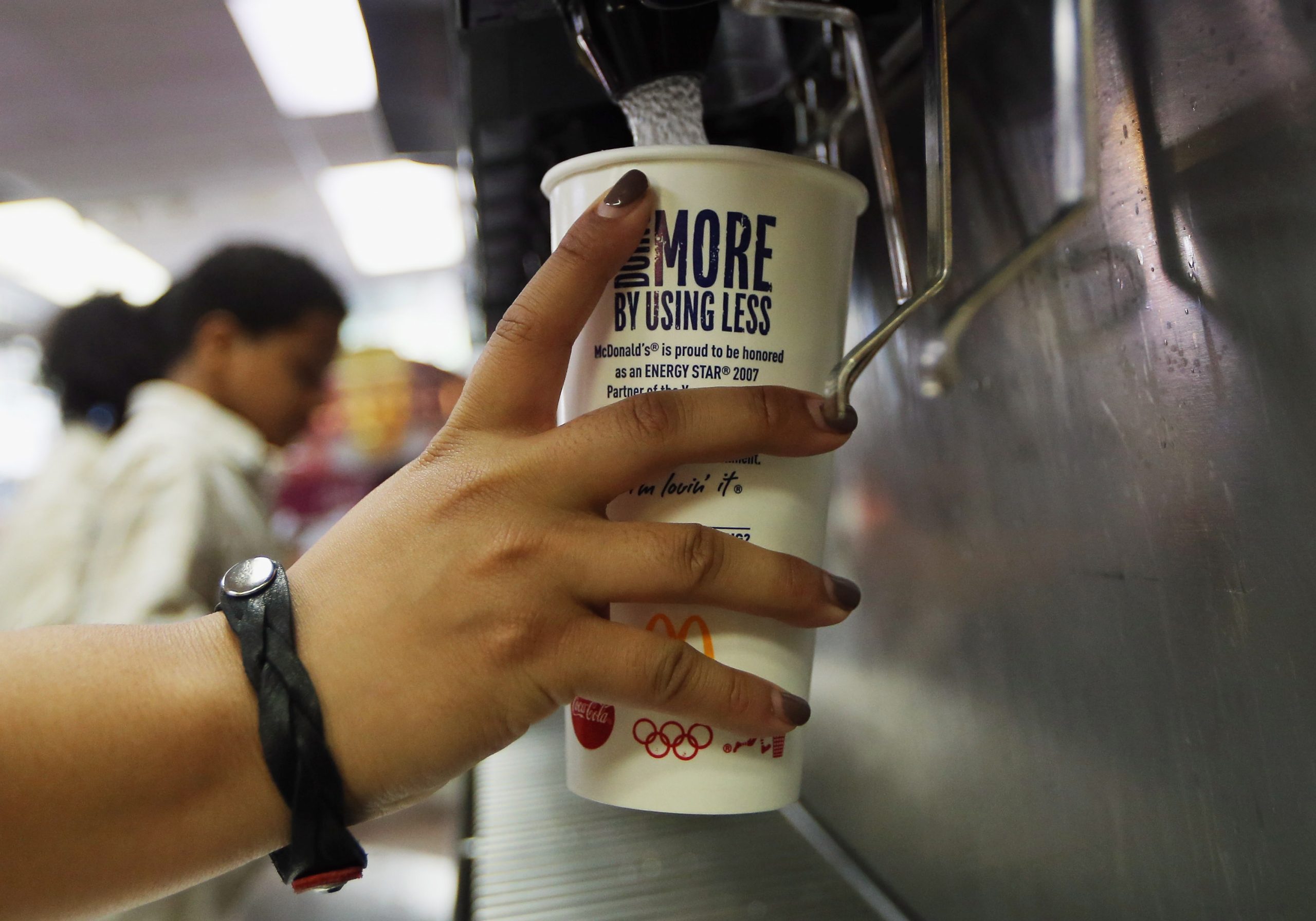 person filling mcdonalds soda with sprite