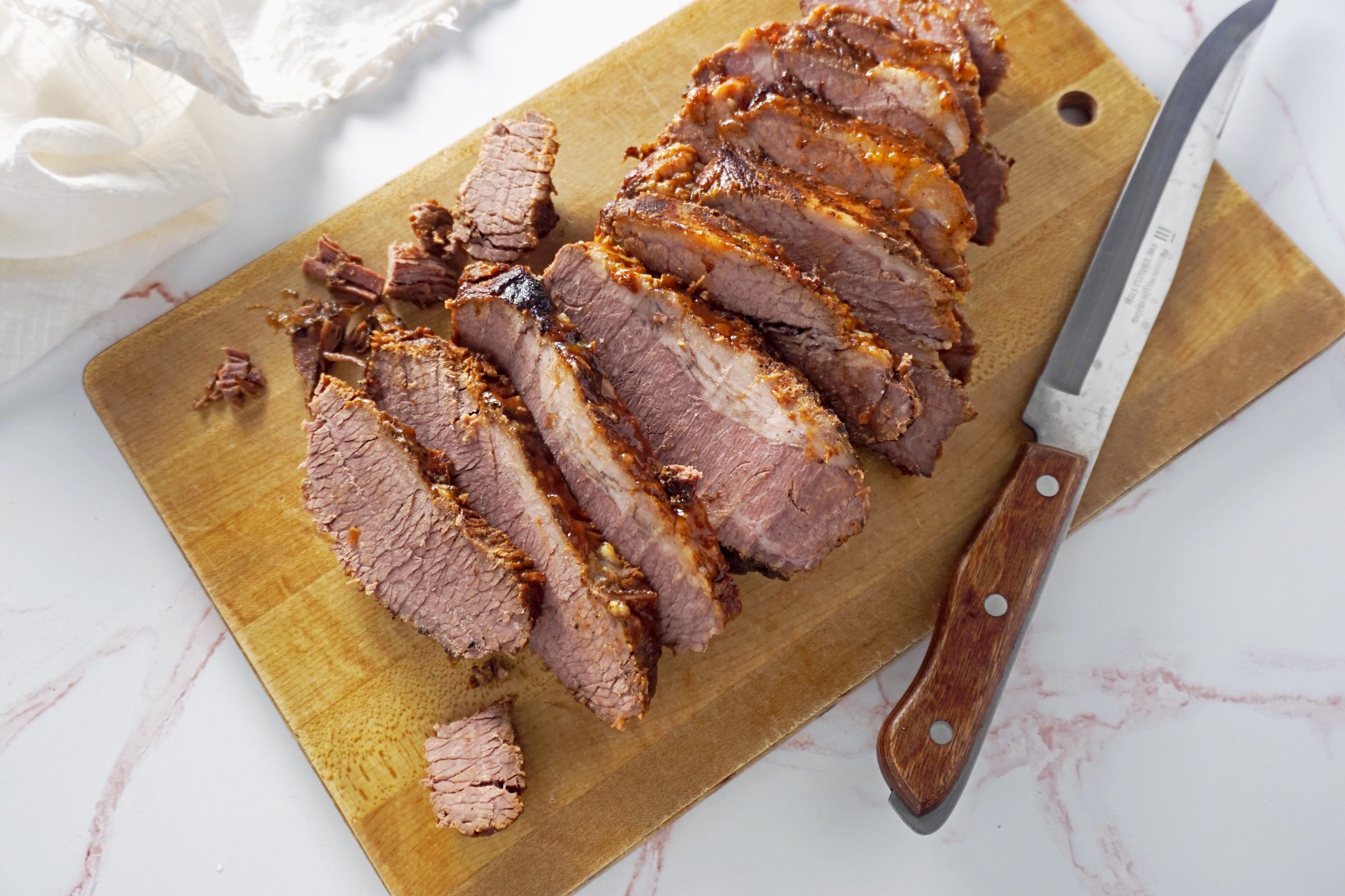 sliced brisket on a wood cutting board