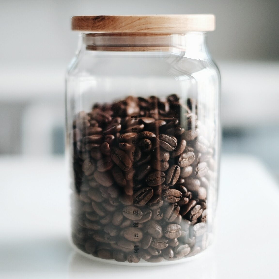 Close-Up Of Roasted Coffee Beans In Jar On Table