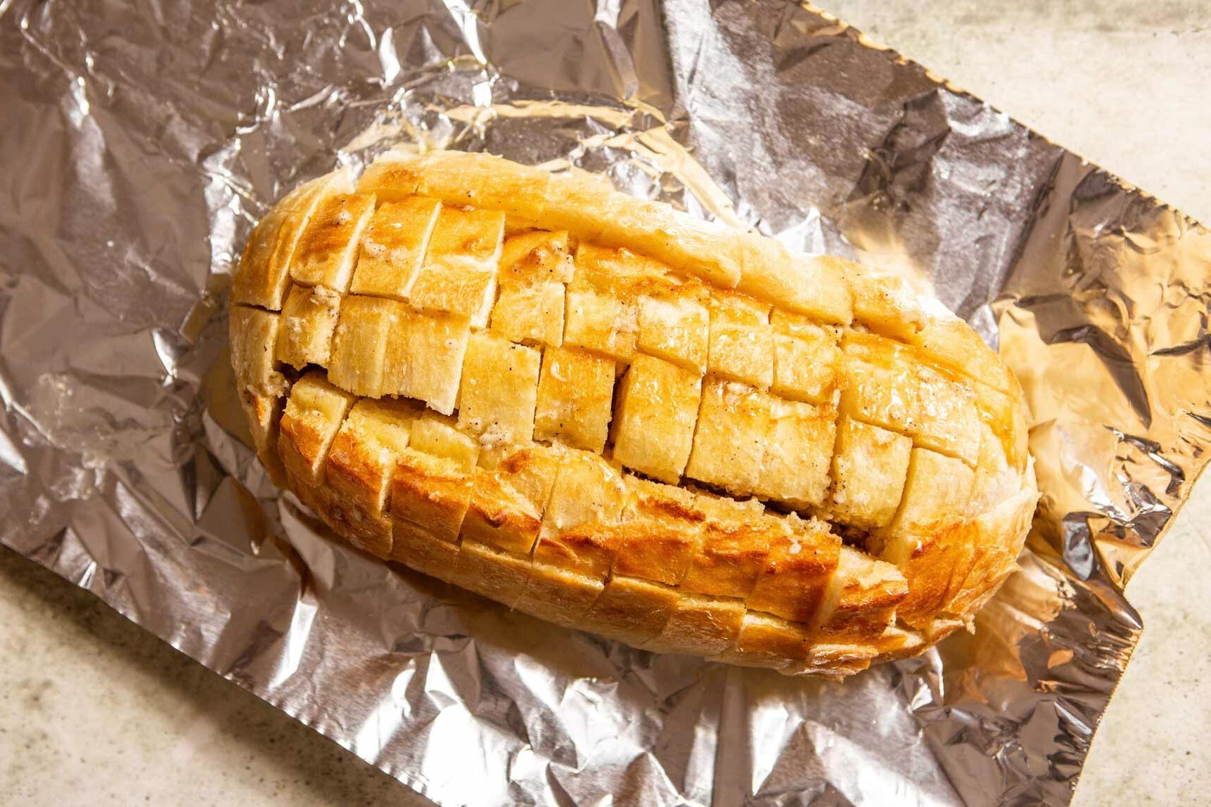 loaf of Bread on aluminum foil cut into a cube pattern