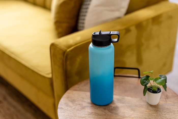 Blue and teal water bottle on coffee table