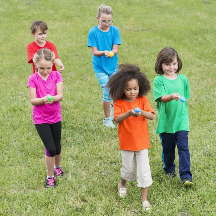 Group of children in egg spoon race