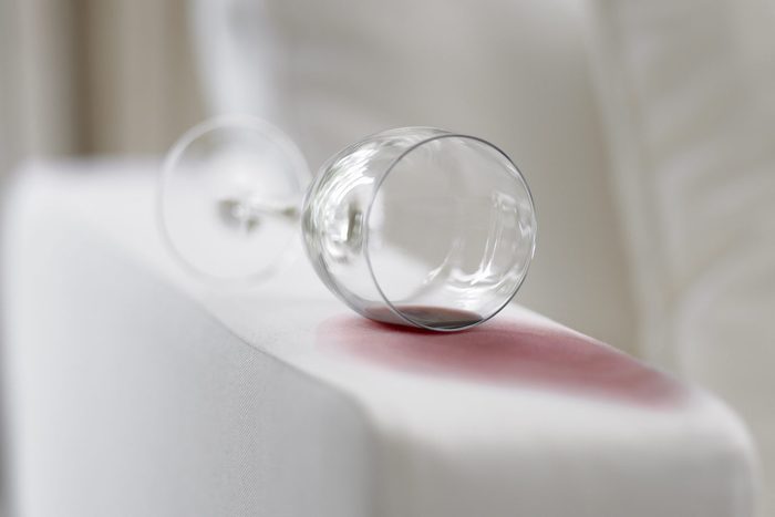 Red wine spill staining sofa