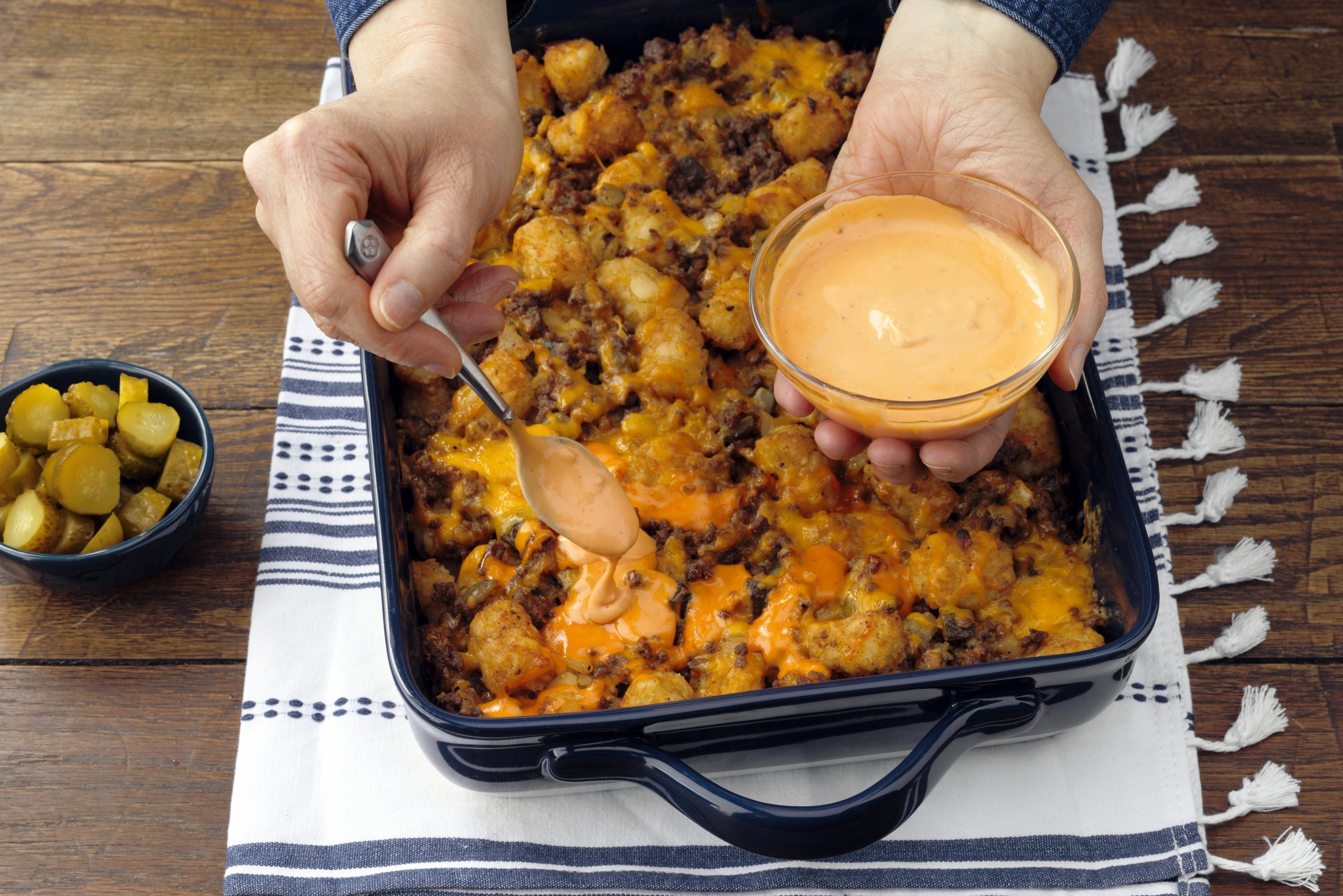 Cheeseburger Tater Tot Casserole With Cheese Sauce Drizzle