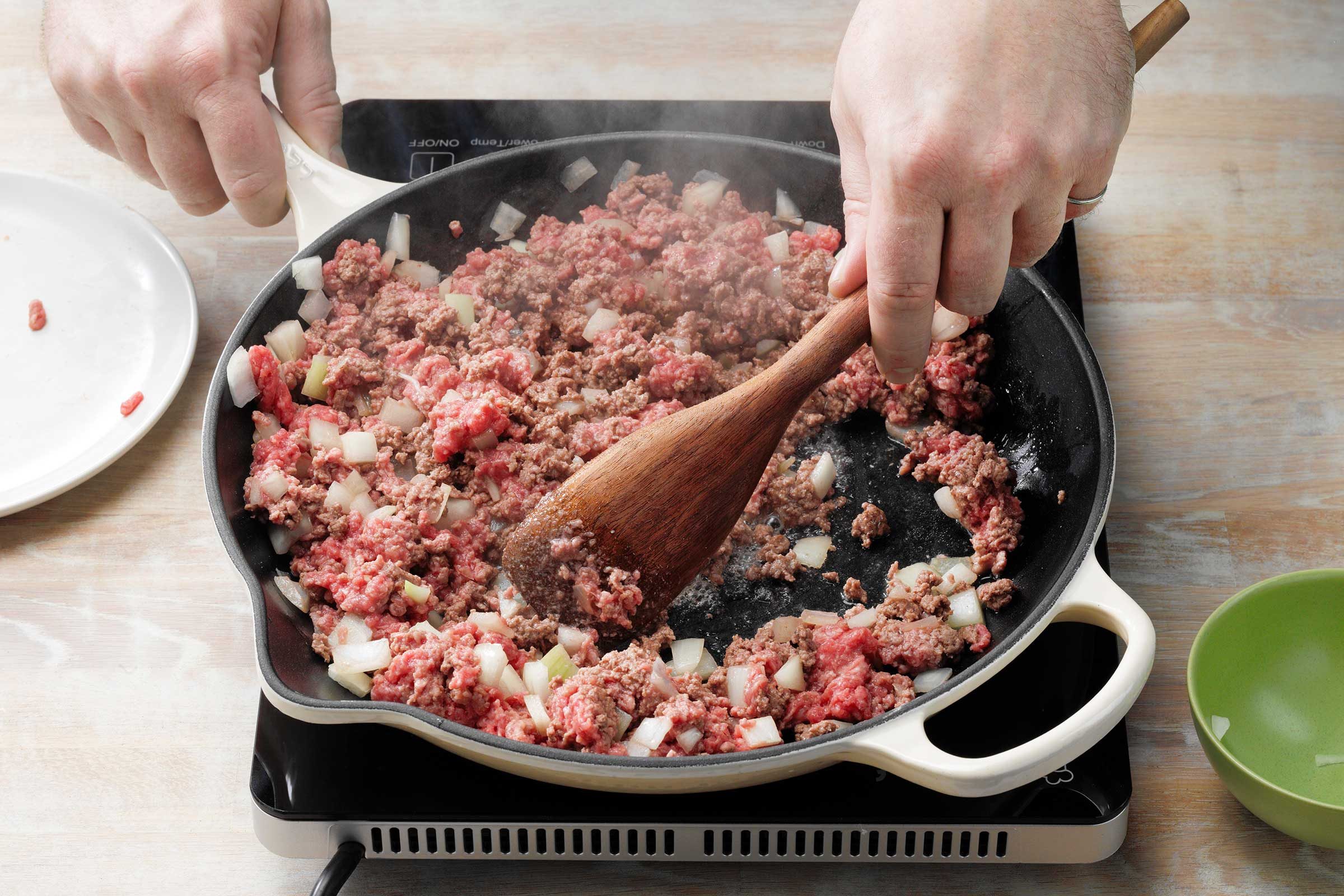 Traditional Stuffed Peppers With Cooking Beef And Onion In Skillet