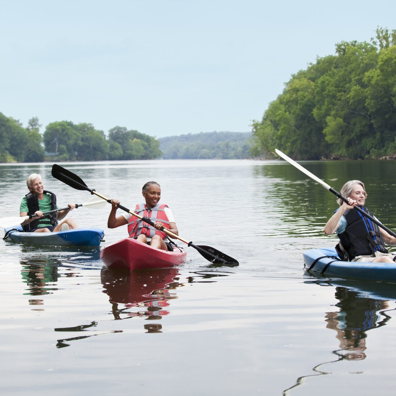 Couples kayaking on river