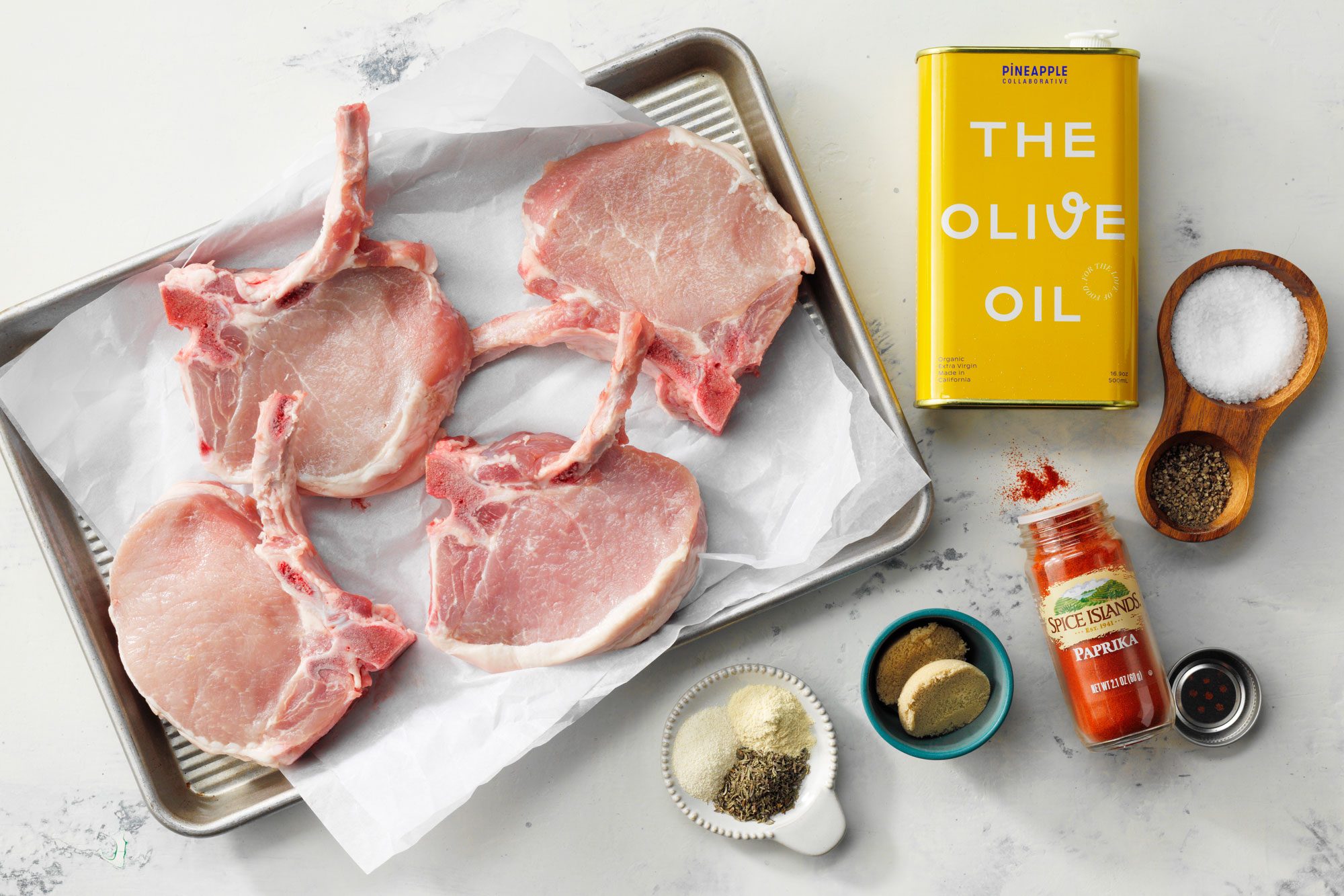Overhead Shot Of All Ingredients For Baked Pork Chops On Marble Surface