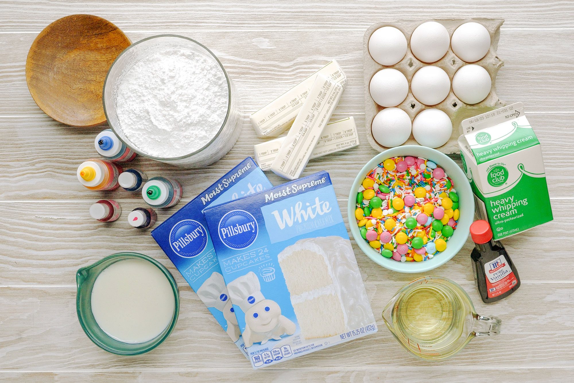 Ingredients Of Surprise Cake spread out on wood surface