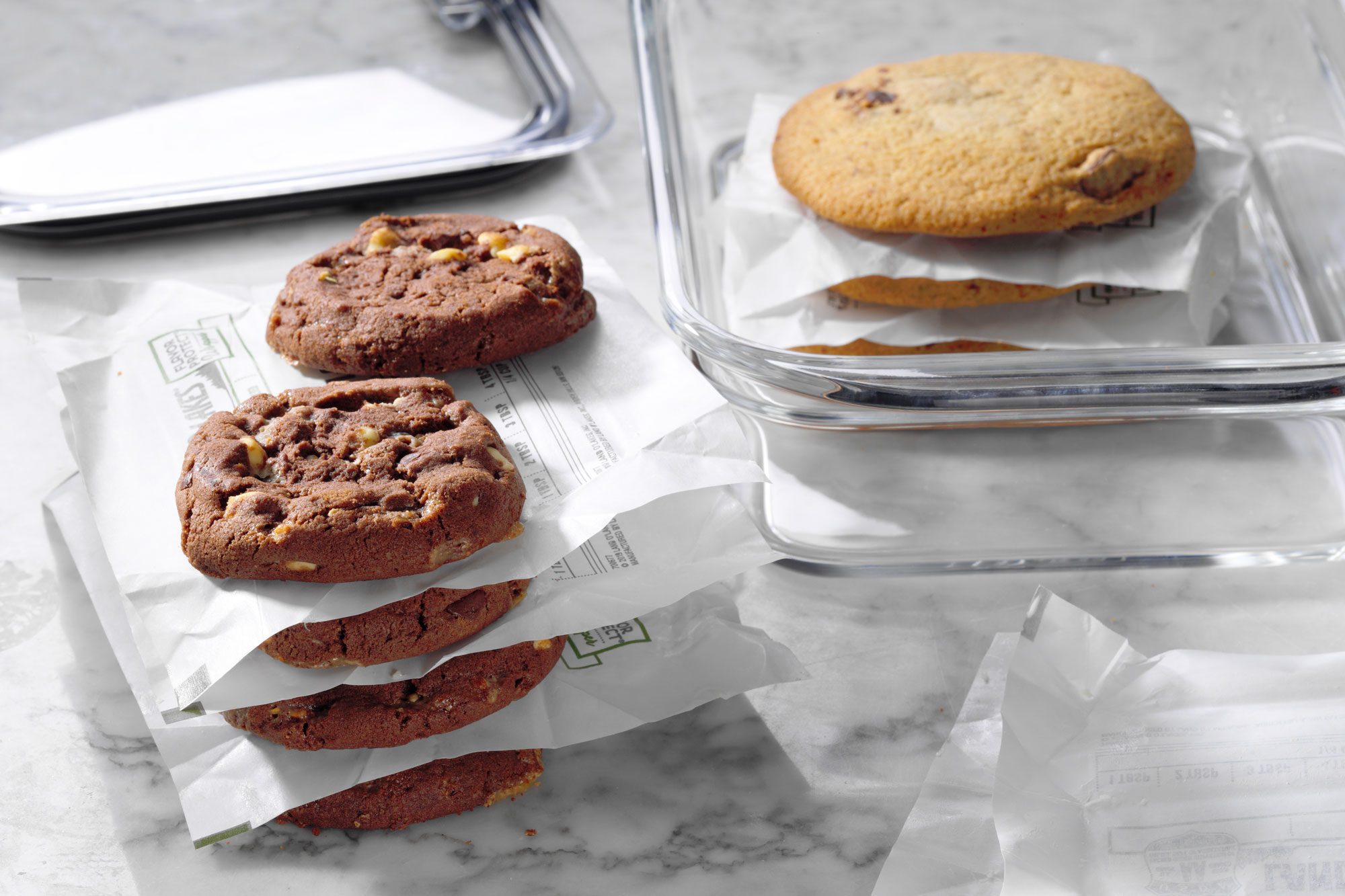 butter wrapper papers in between stacks of cookies being packed for freezing