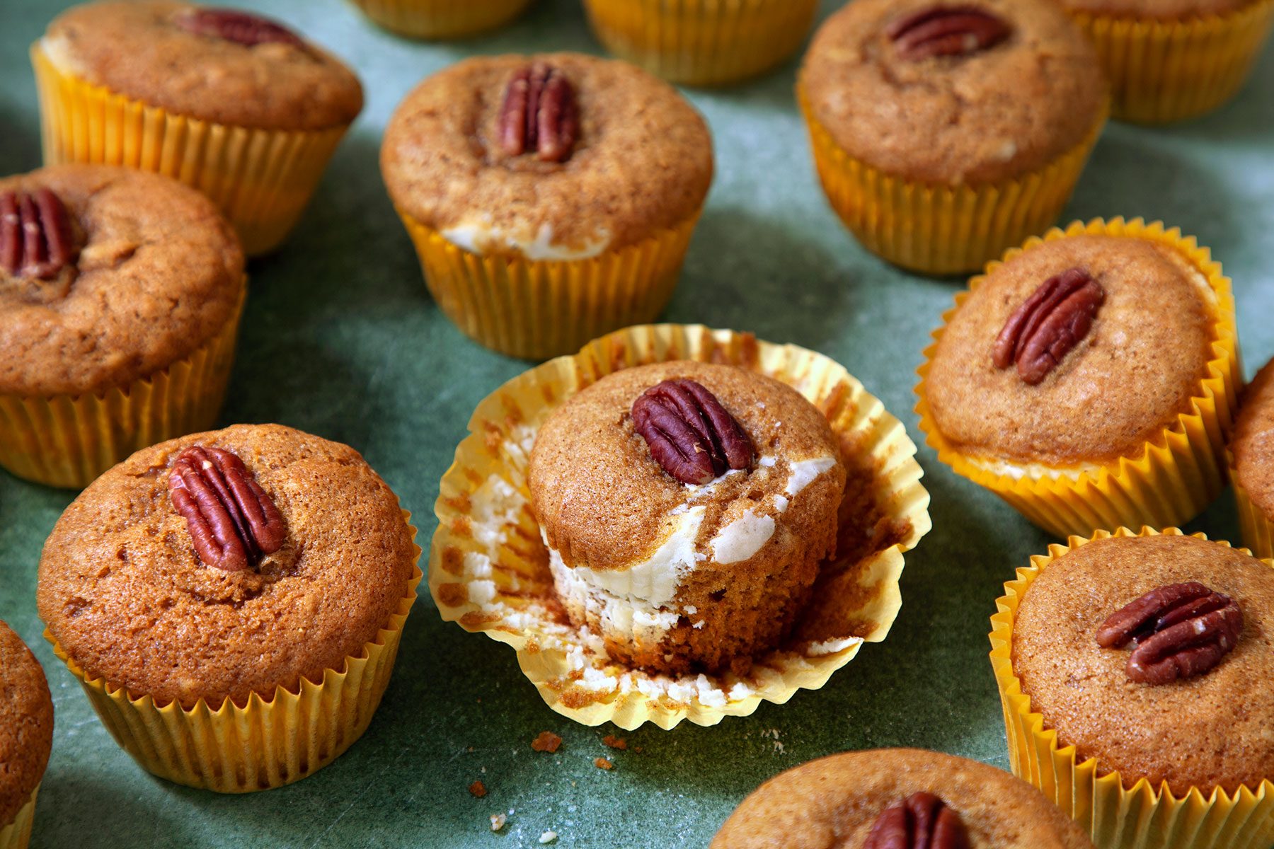 Pumpkin Cream Cheese Muffins on Green Background