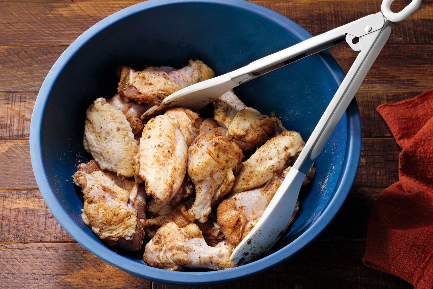 Chicken coated with spices mixed in a bowl