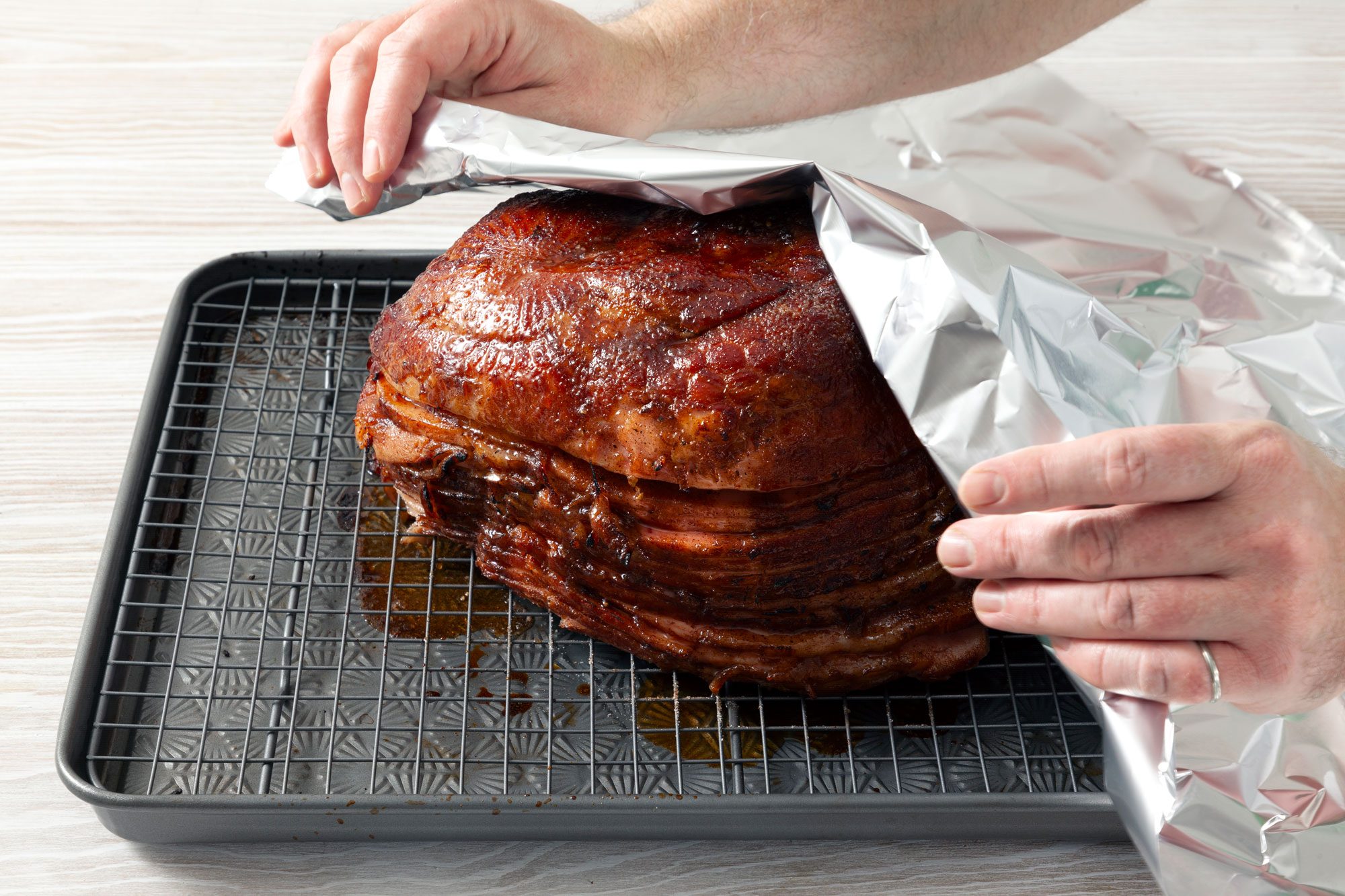 Tent the ham with foil