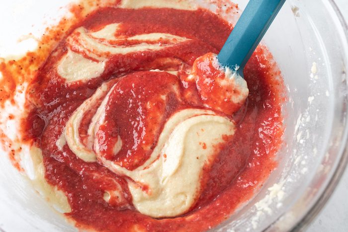 Folding Strawberry Puree in a large bowl