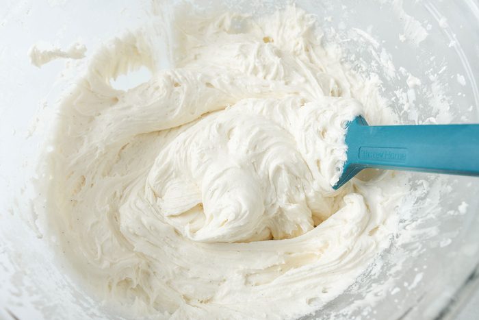 folding the frosting in a large bowl