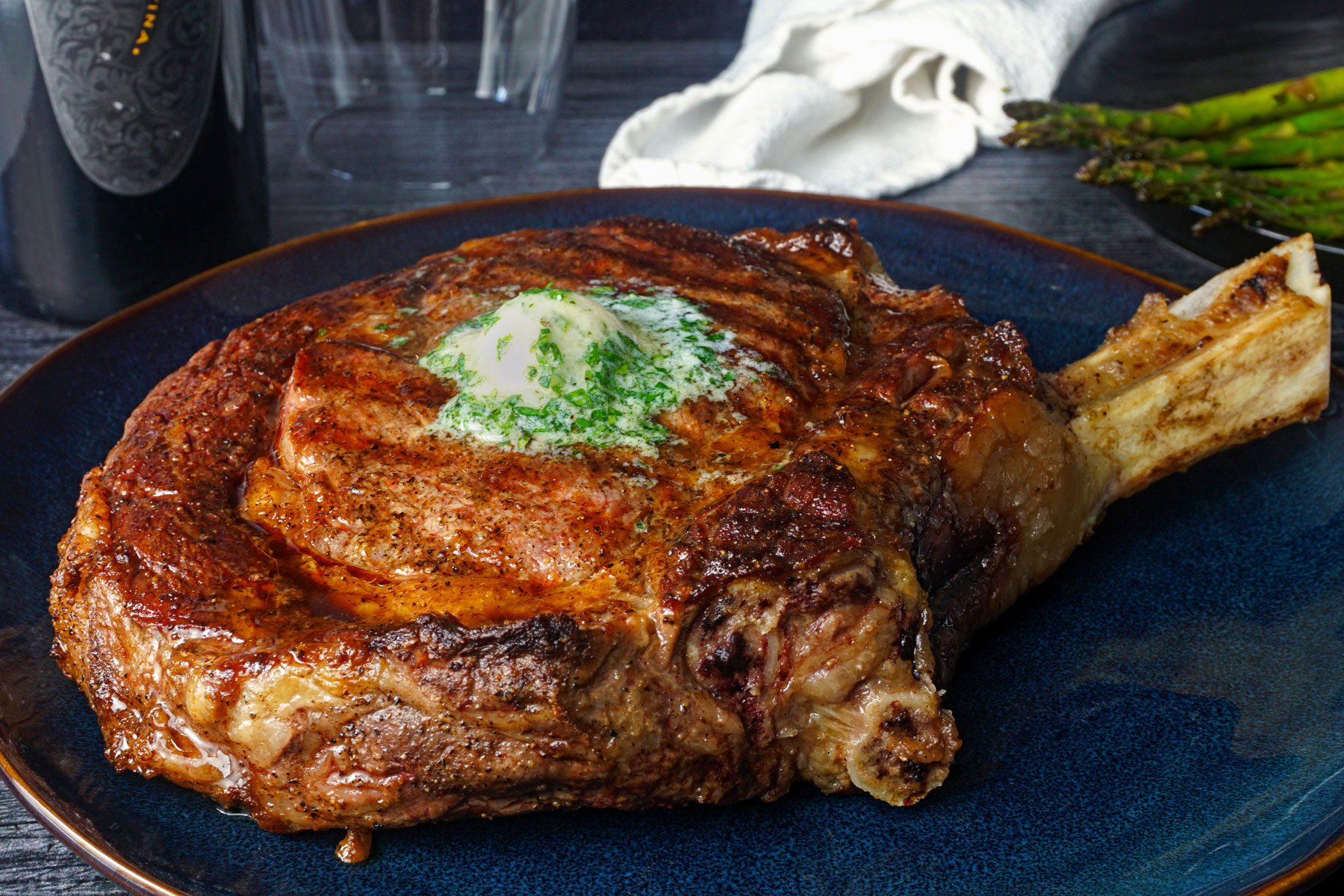 Prepared Cowboy Steak steak with a generous slice of ranch butter