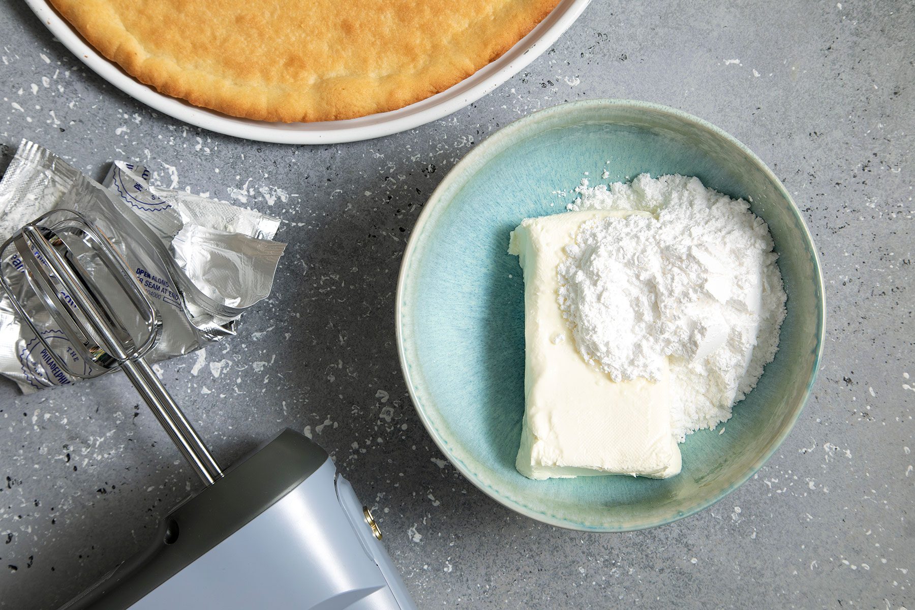 Cream cheese and sugar in a bowl