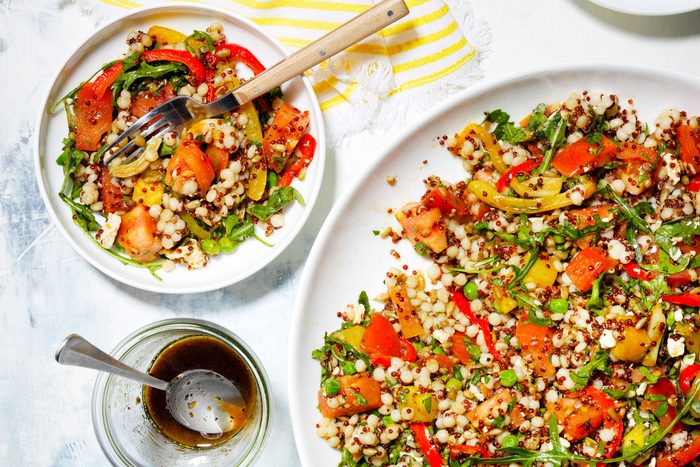 Summer Salad served in plate with fork, laced on a countertop