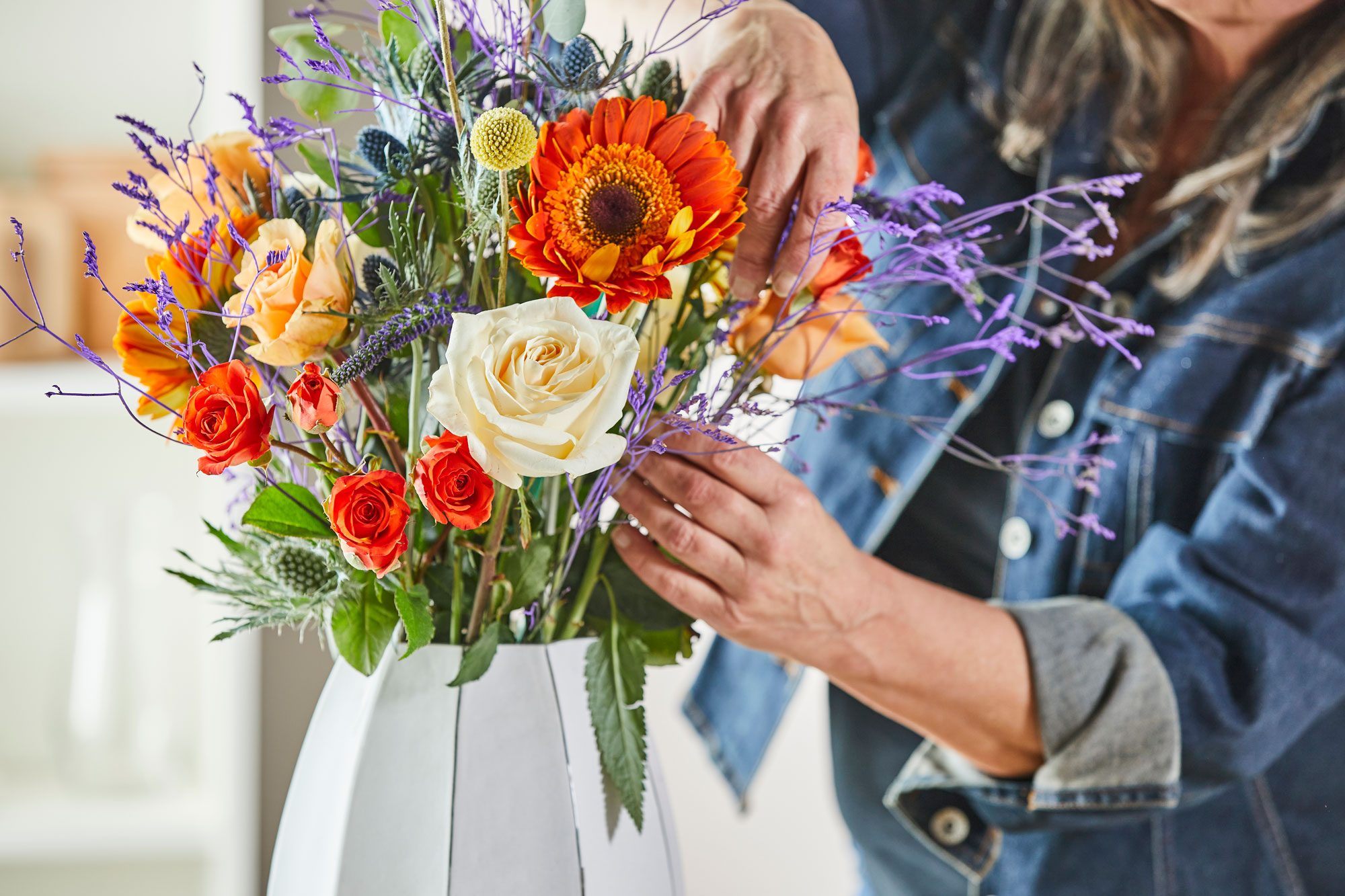 someone arranging flowers in a vase , The Best Flower Delivery In 2024