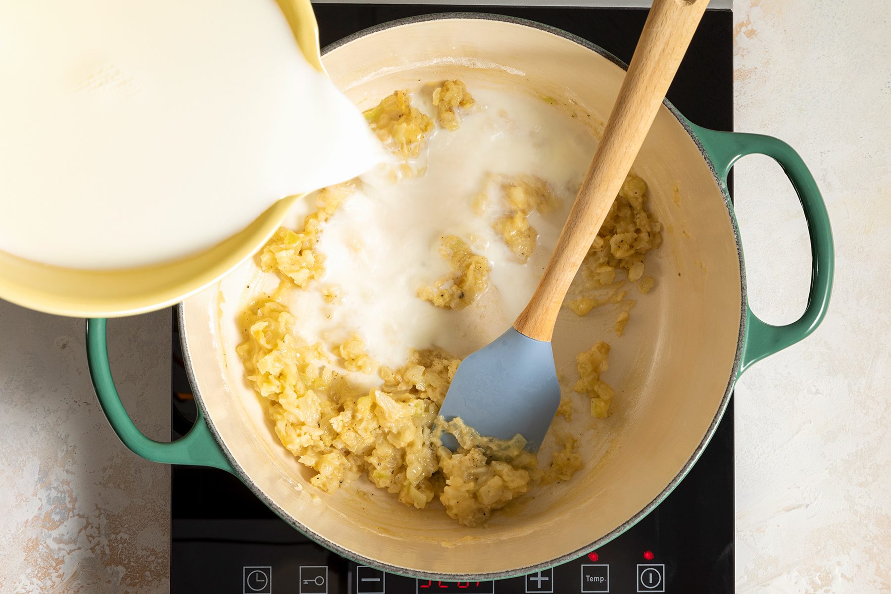 adding milk in Dutch oven