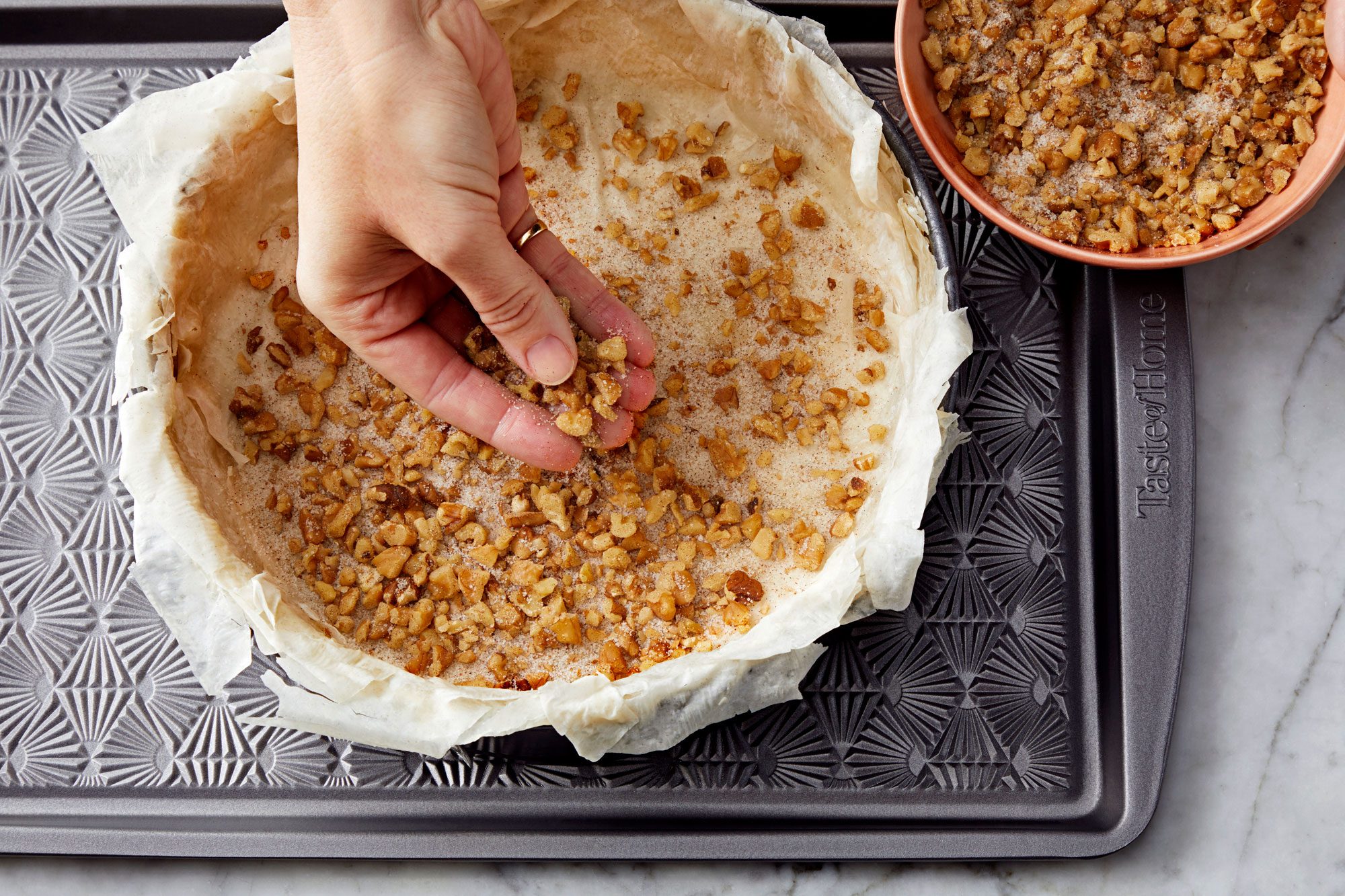 Sprinkle the mixture of chopped walnuts, sugar and spices over the phyllo