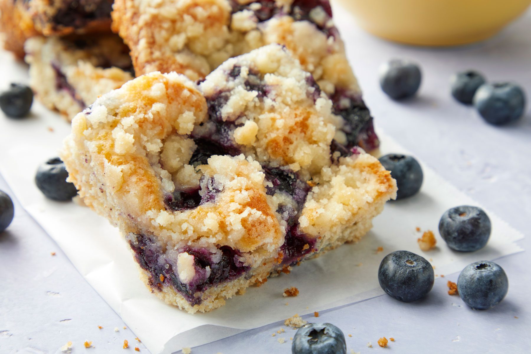 A close up of Blueberry Kuchen on a marble countertop with blueberries