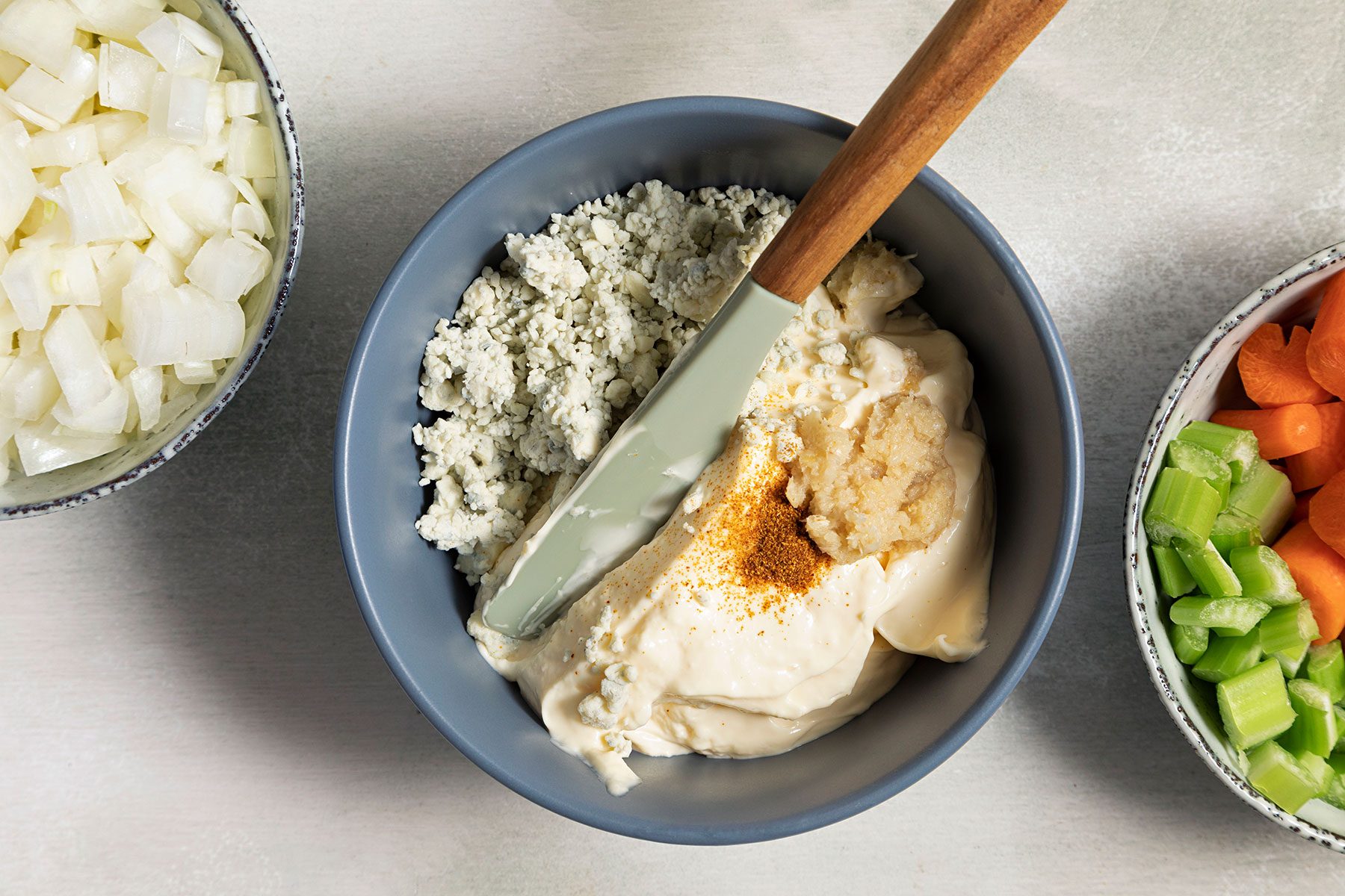 Preparing blue cheese mayonnaise in a small bowl with spatula 