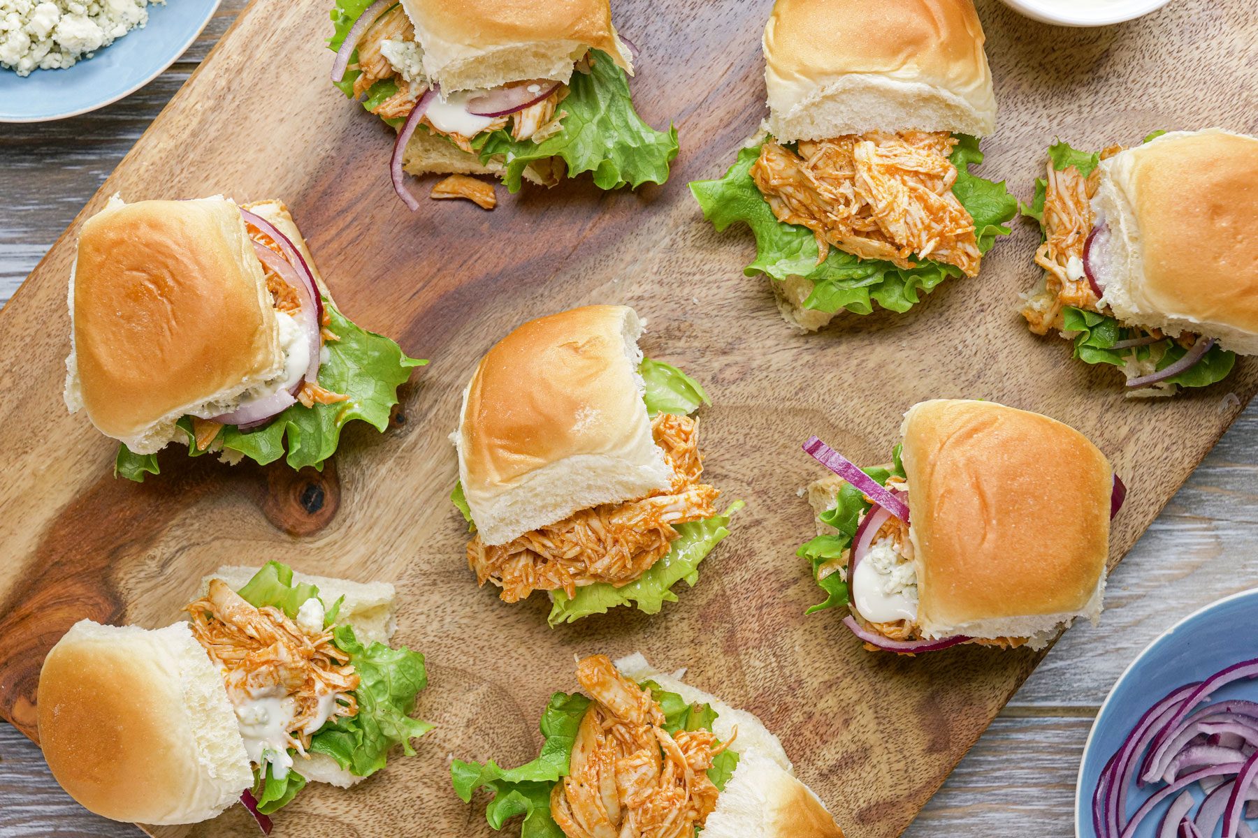 Buffalo Chicken stuffed in buns served on a wooden tray