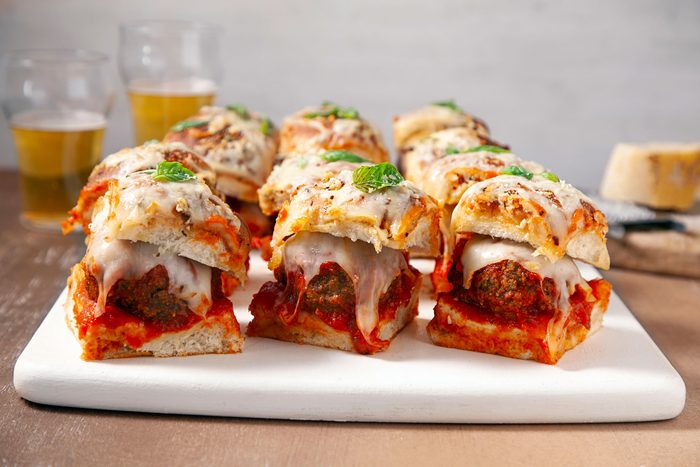 Cheesy Meatball Sliders in a white plate on a wooden table