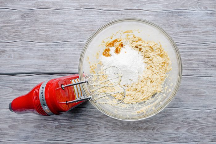 Beating the pudding mix and vanilla