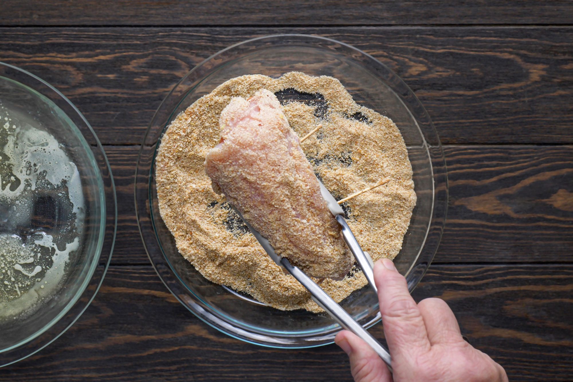 Coating Chicken Breast Roll with Bread Crumbs, Wooden Background