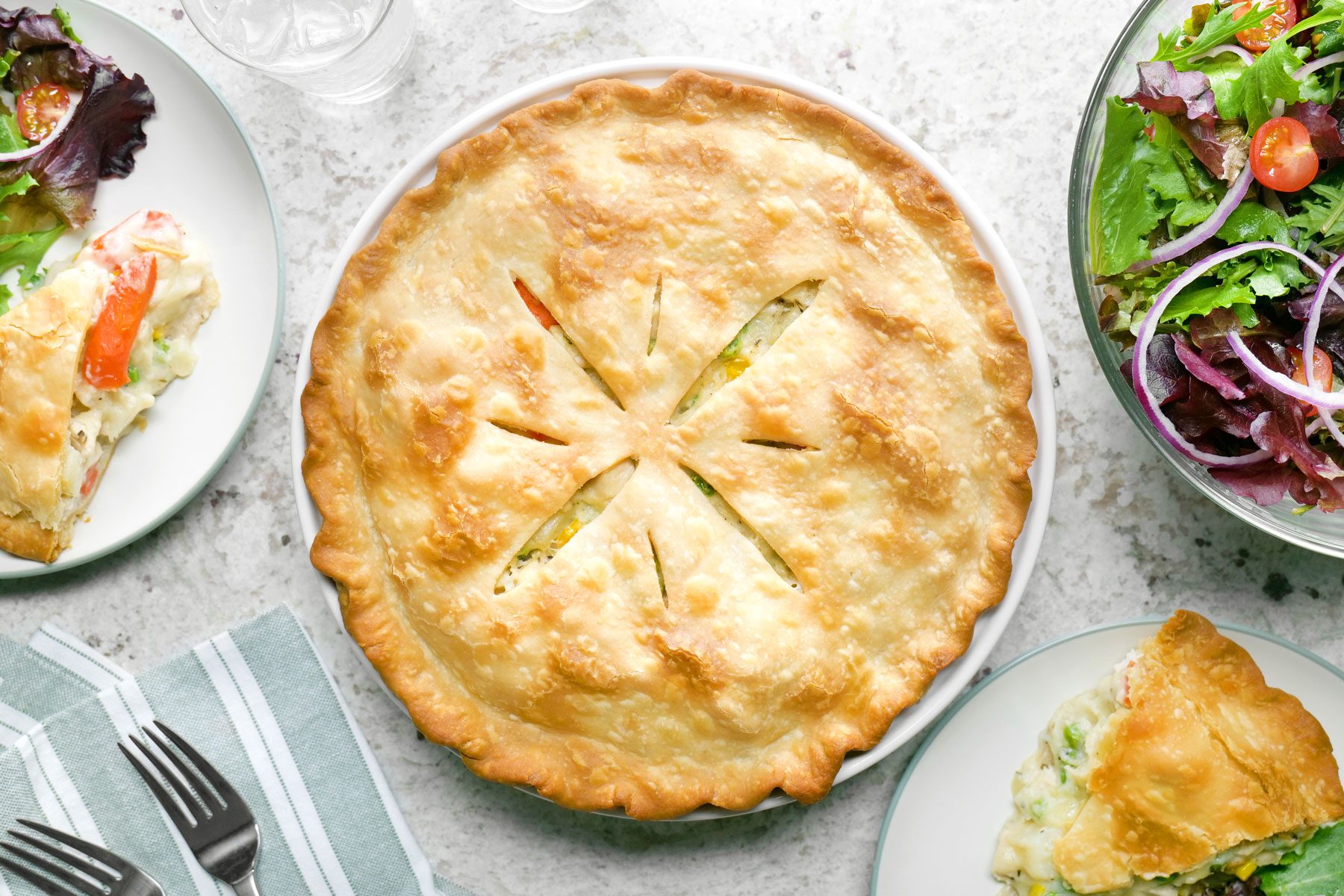 A fully baked Chicken Potpie served in a plate on a kitchen countertop.