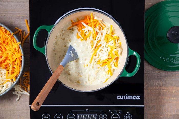 Cheese milk and onion mixture in a saucepan