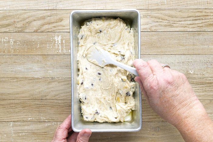 Chocolate Chip Banana Bread Batter in a loaf pan on a wooden surface