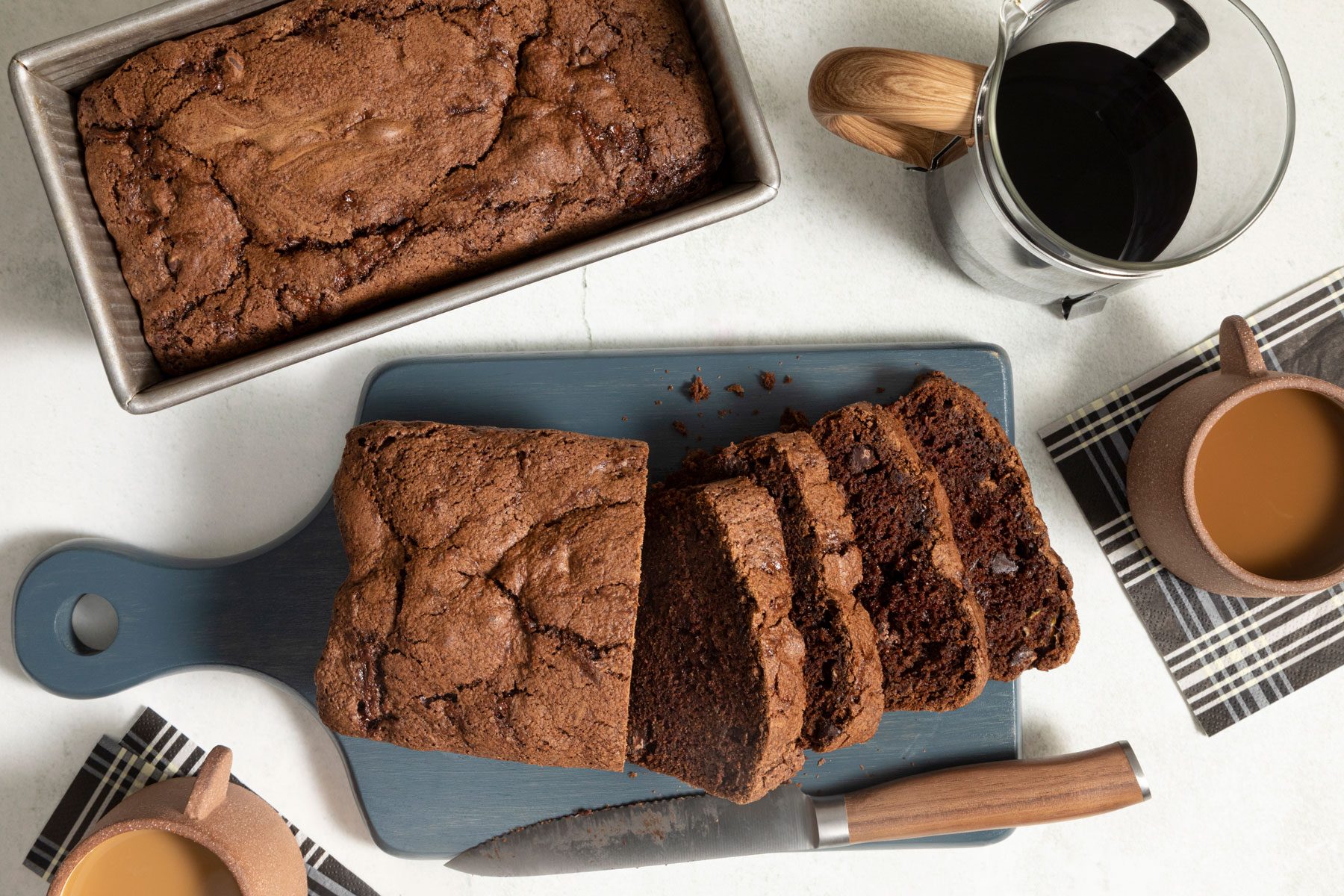 Chocolate Zucchini Bread served in a tray with a beverages.