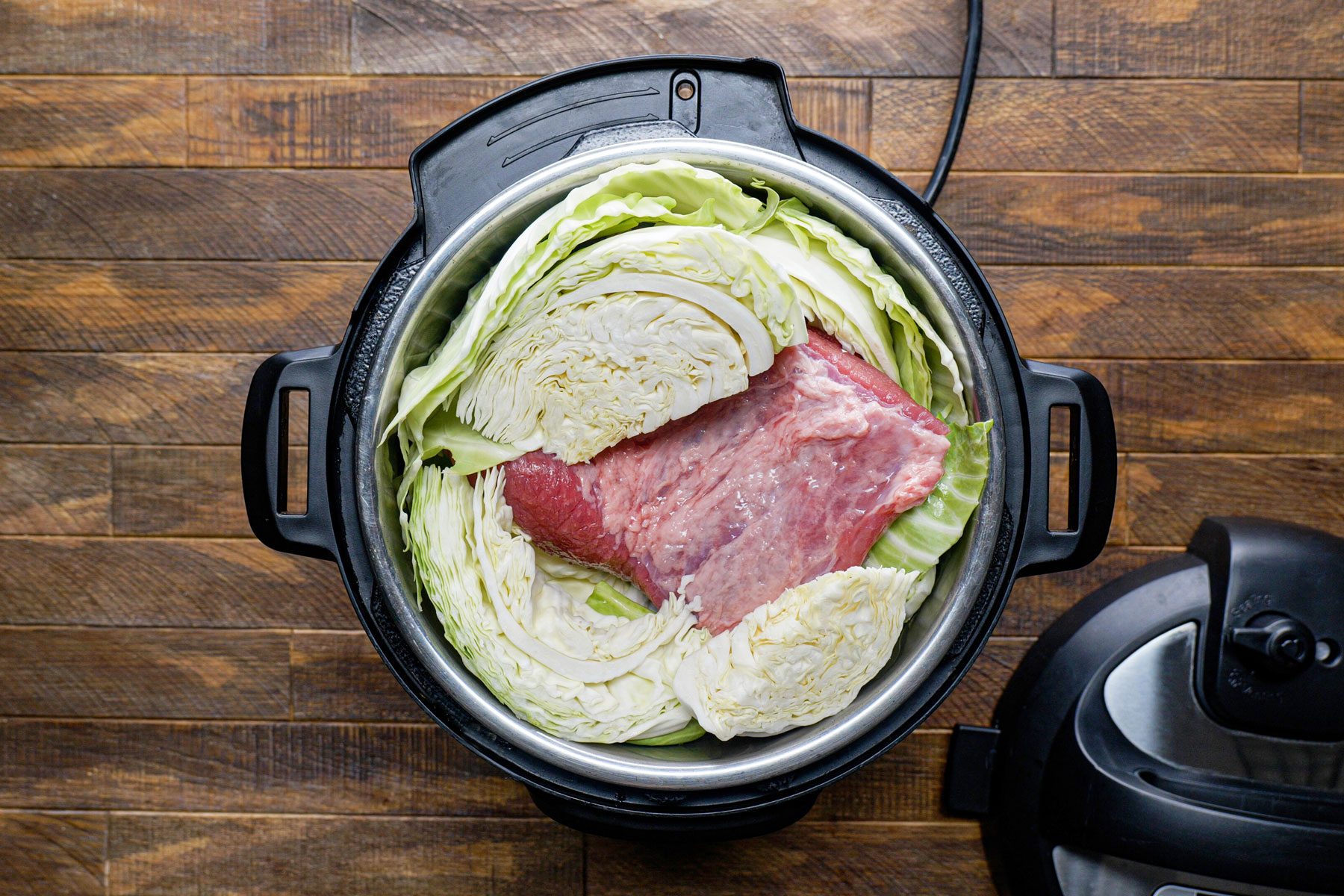 Brisket and cabbage placed in the slow cooker