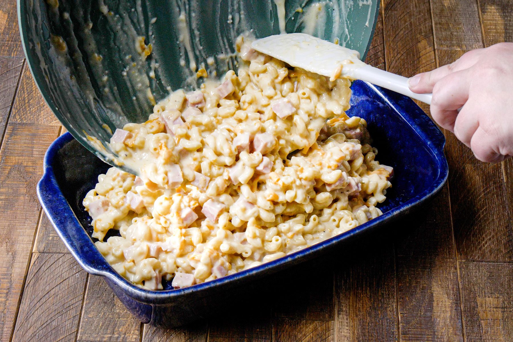 Pouring pasta in a large baking dish