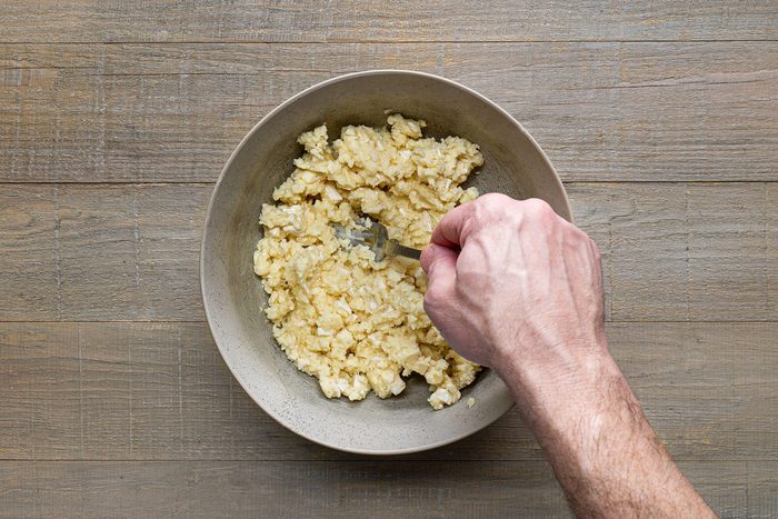 Mashing Camembert cheese with a fork