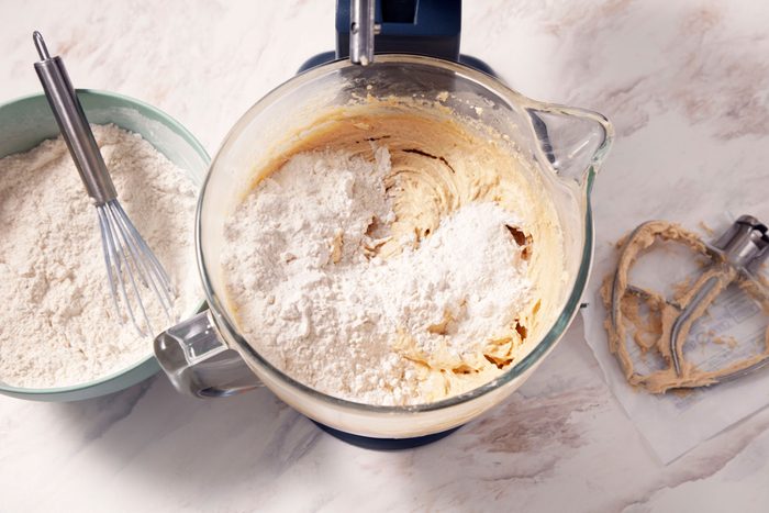 Mixing the flour into the creamed mixture in a blender
