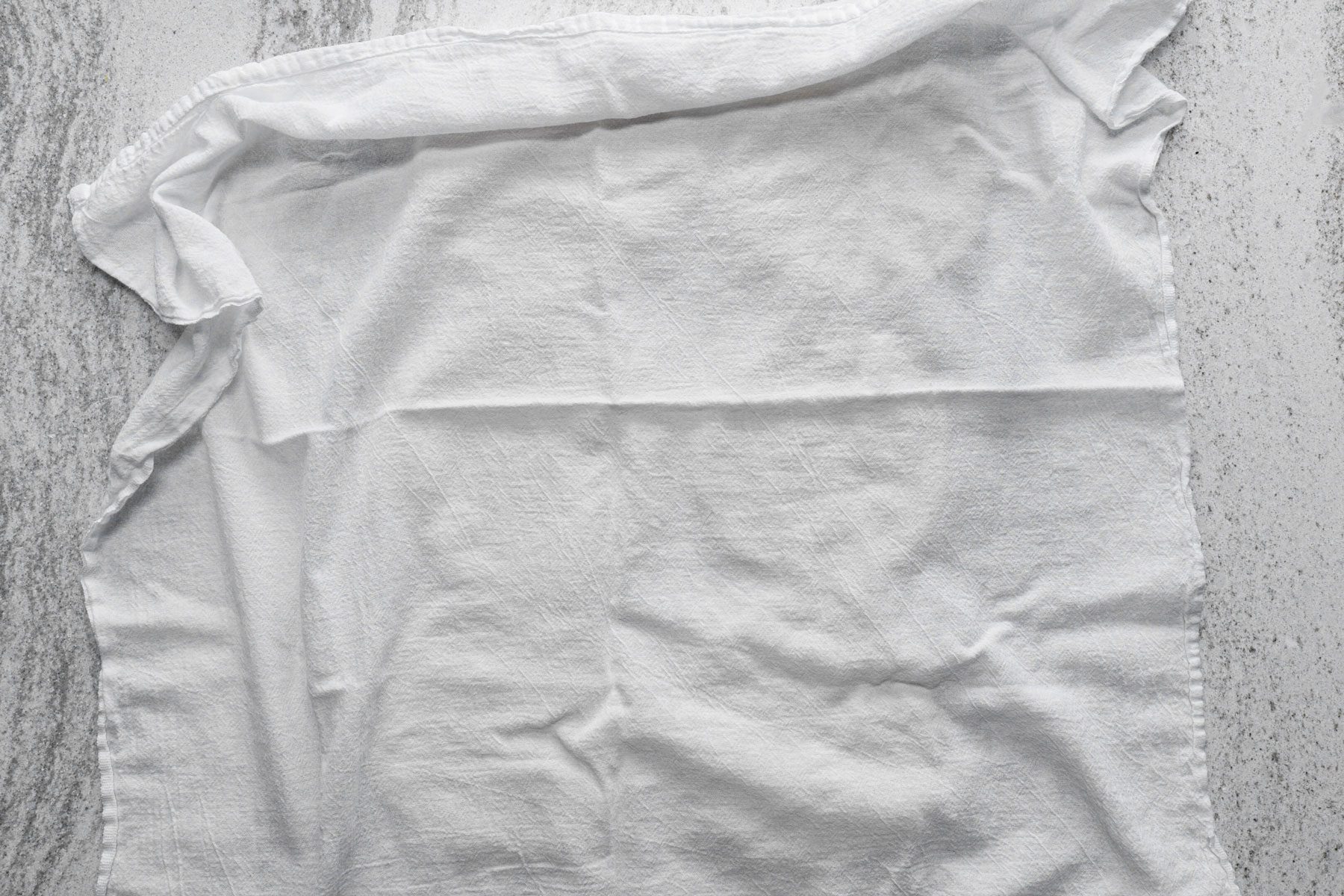 A piece of white cloth on a kitchen countetop