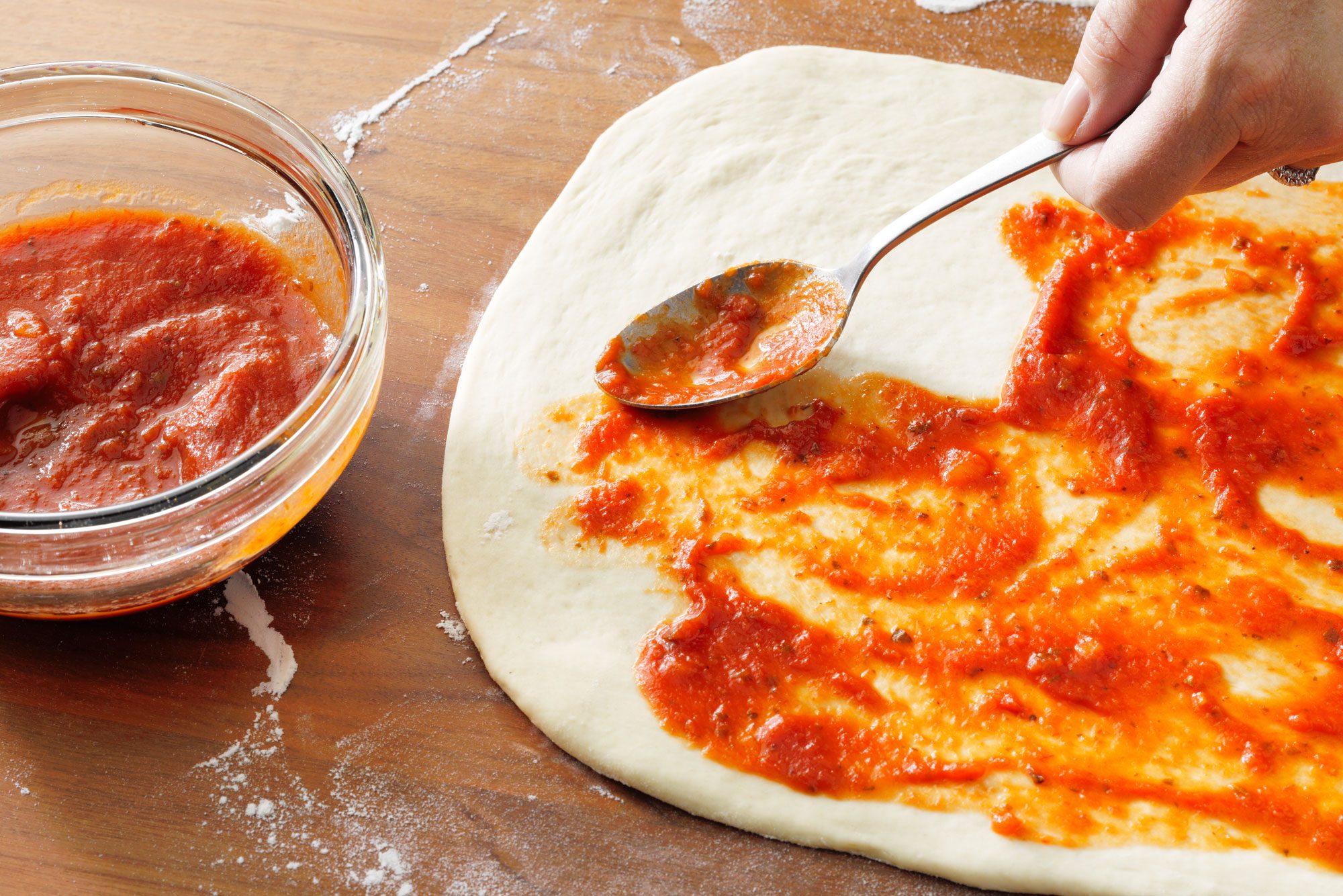 Spoon the pasta sauce over the dough