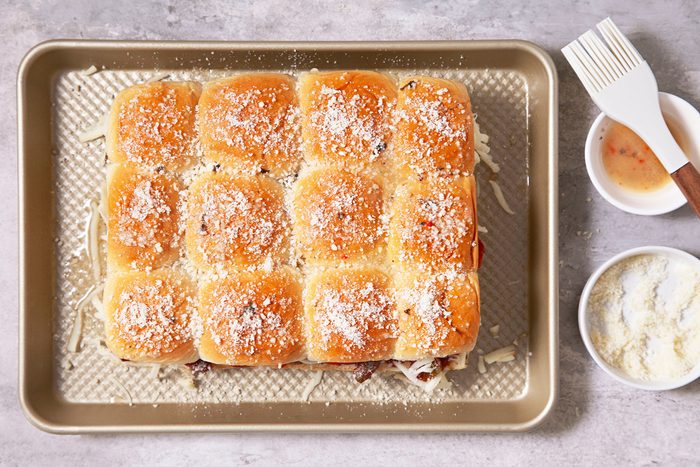 Parmesan sprinkled on top half of the pizza slider