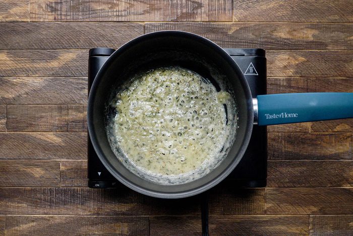 Melting Butter in a Saucepan on a gas stove on a Wooden Surface