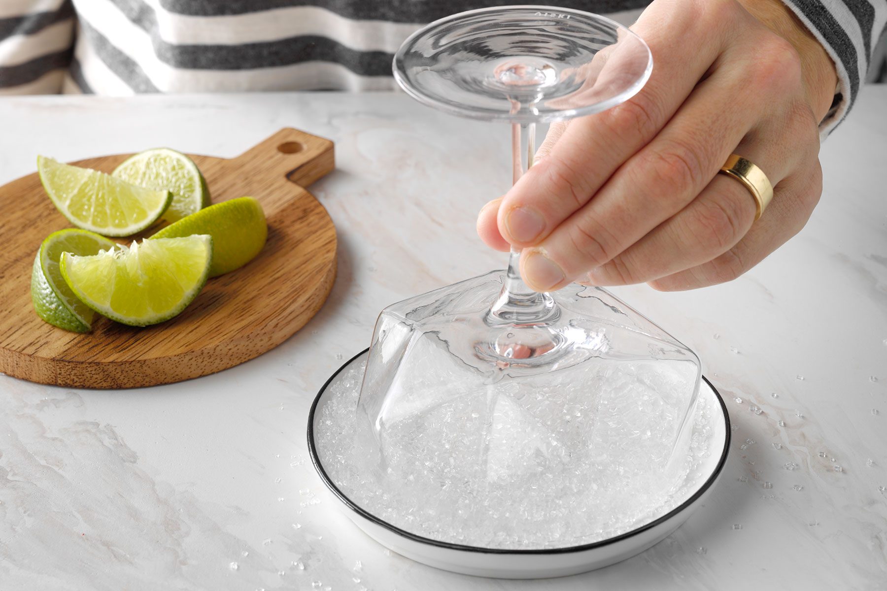 Dipping the glass into sugar spread to coat the glass rim
