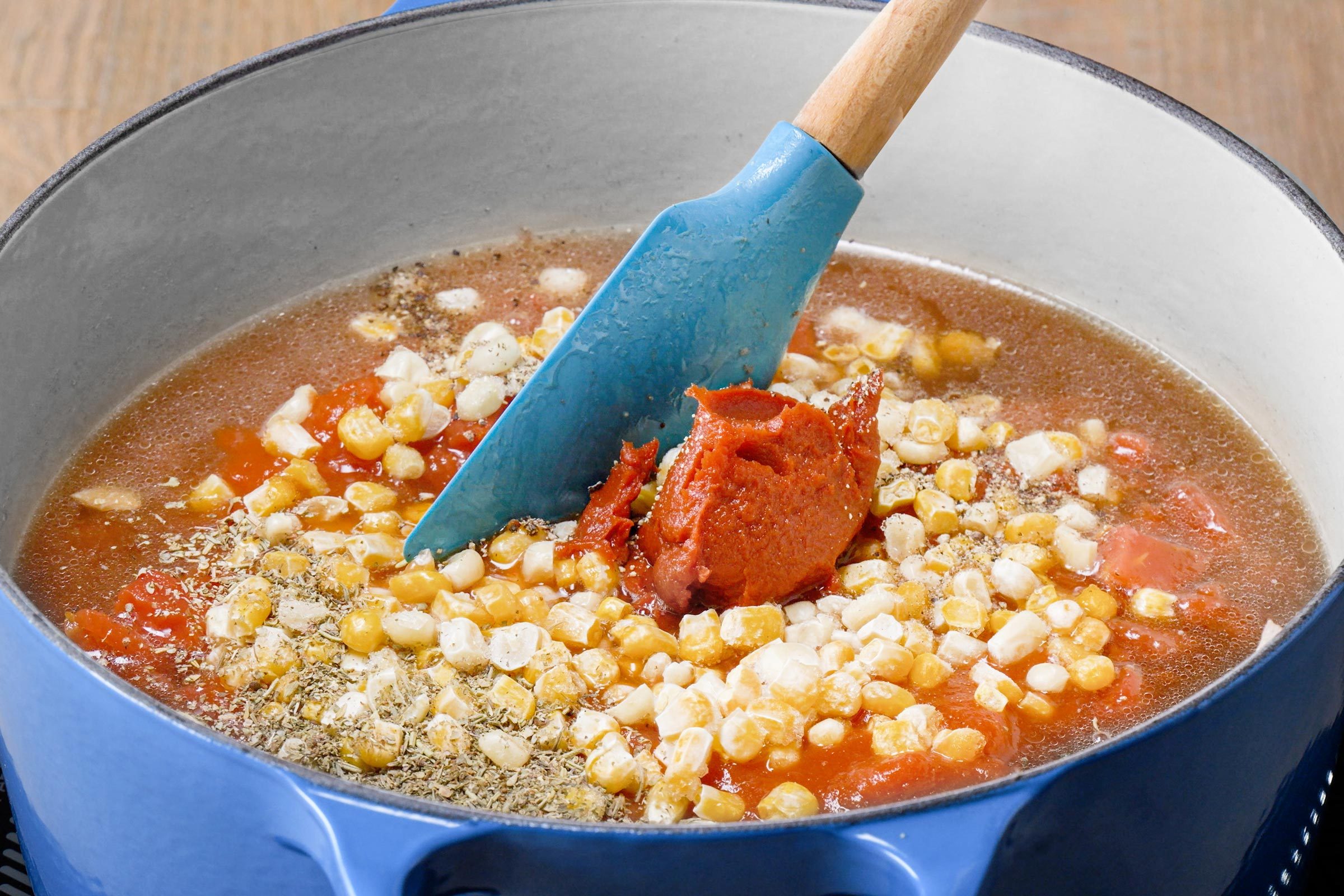 adding rest of the ingredients to a large stock put with lasagna soup