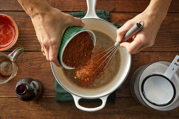 whisking beer and cocoa in small pot on hot plate