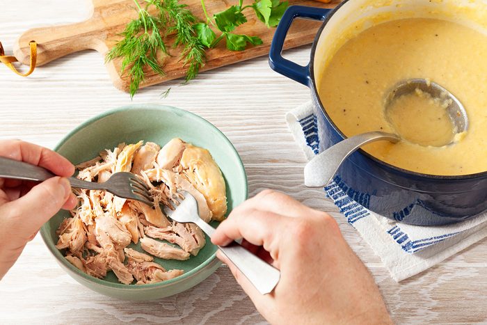 Shredding the chicken with forks