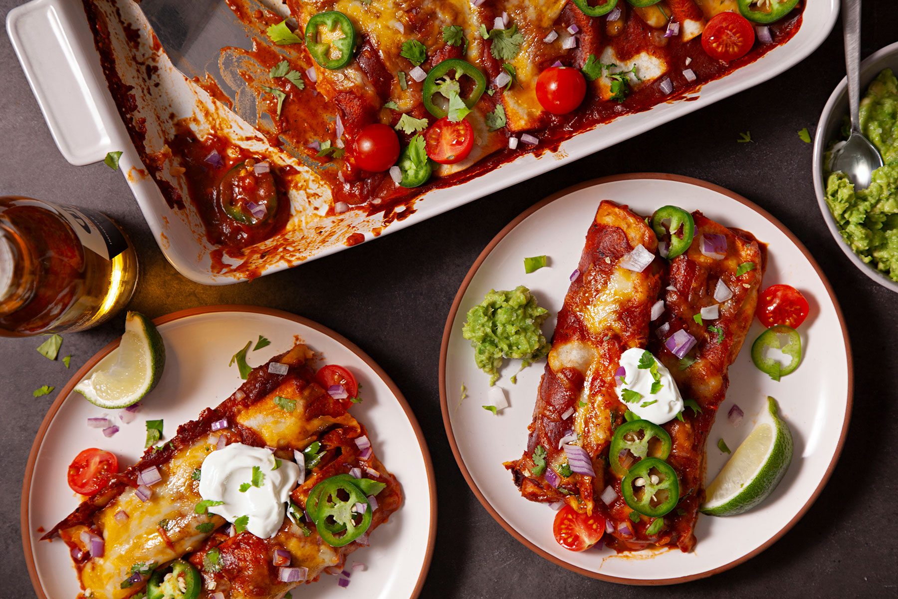 Served the Beef Enchiladas on a plate with toppings with drink on side