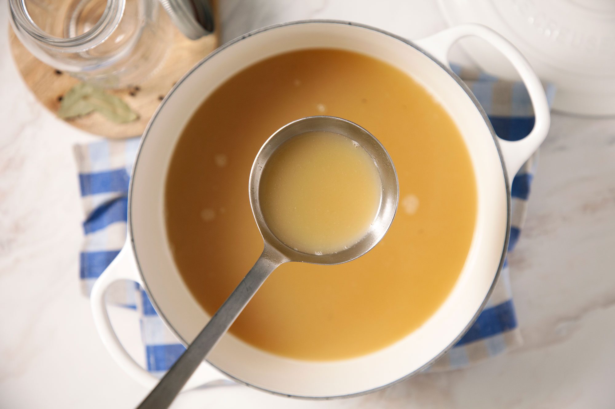 Homemade Chicken Broth in the pan with the spoon
