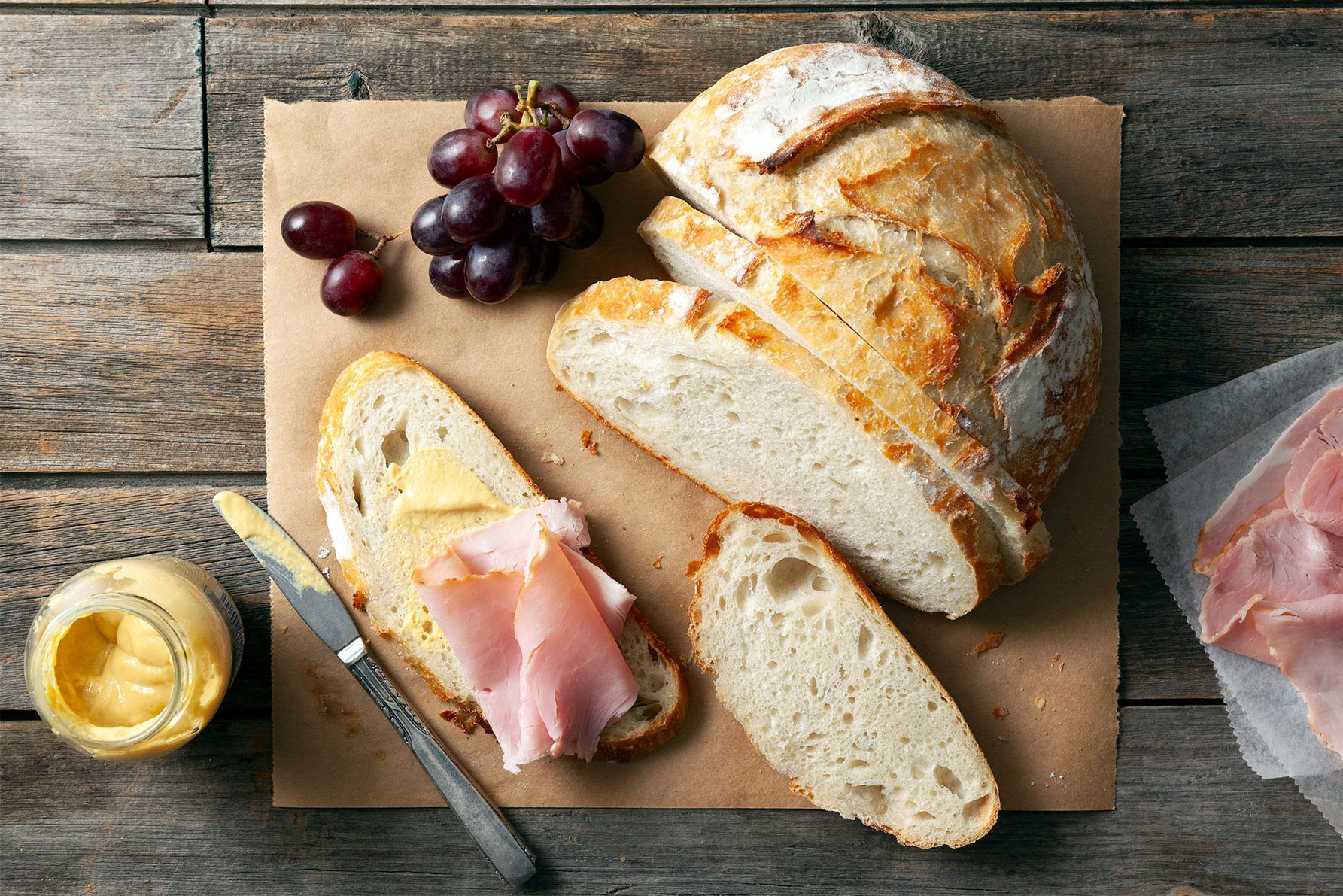 Crusty Homemade Bread served with meat slices on wooden base