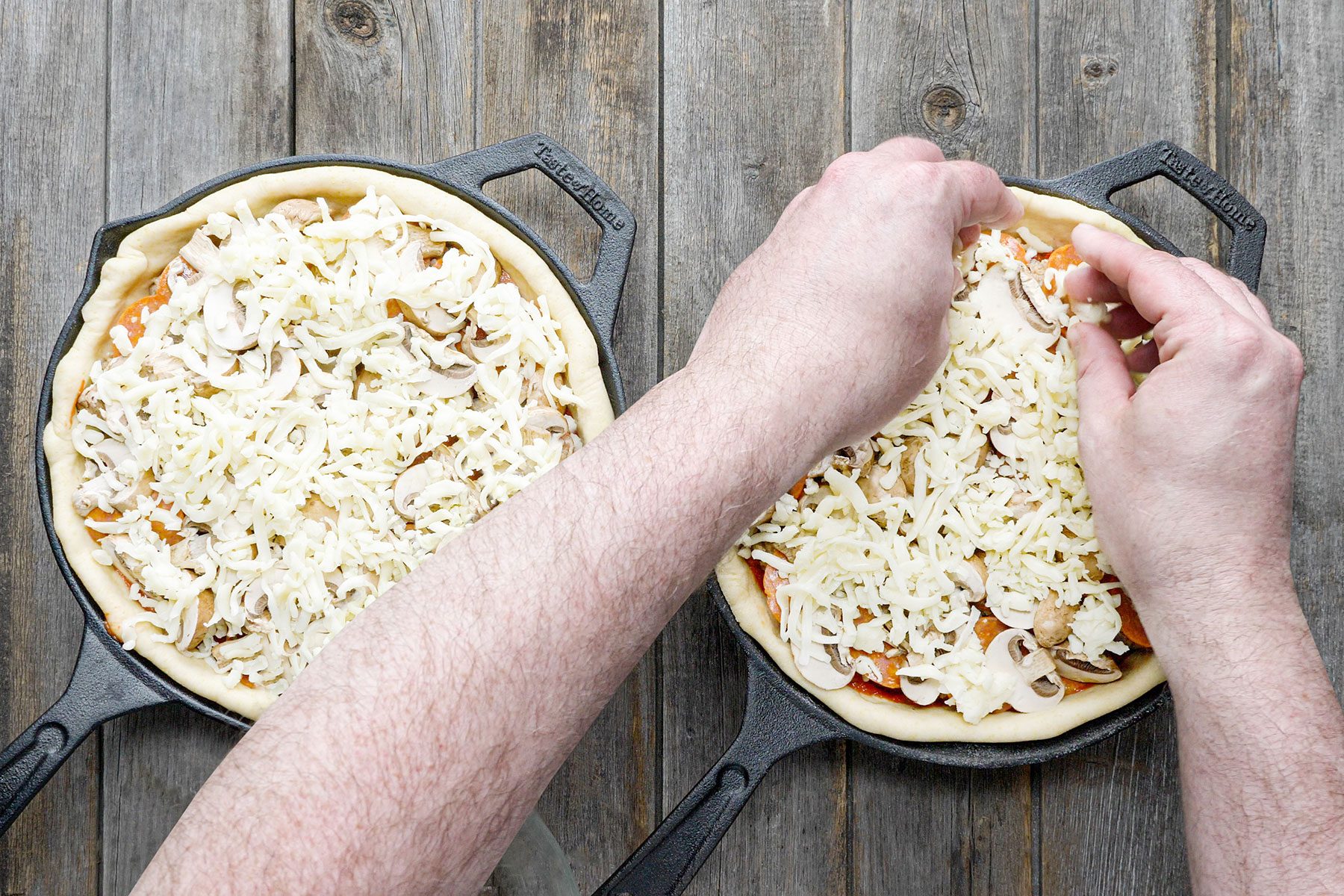 Topping off the toppings with sprinkling more mozzarella cheese